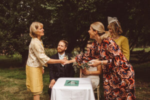 Mother-of-the-bride and Mother-of-the-groom witnessing a wedding certificate signing with humanist celebrant, Jane Blackman
